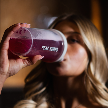 fitness model with drinking peak supps pre-workout in protein shaker 